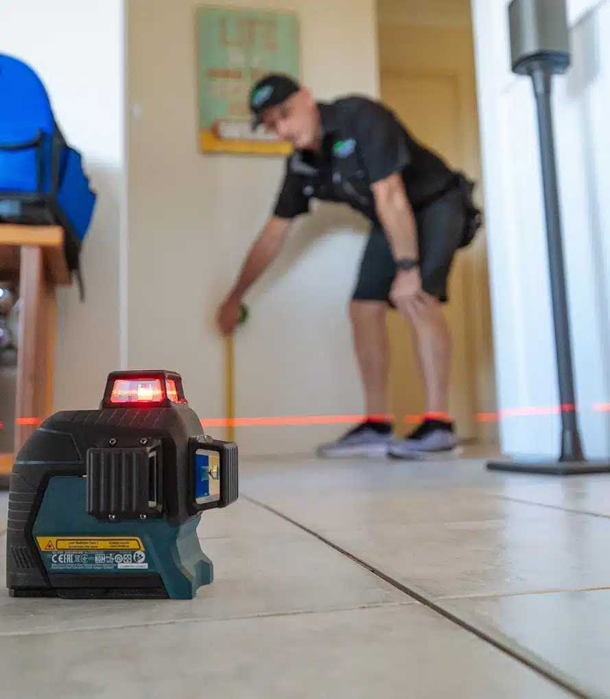 laser level measuring floor movement during a building inspection